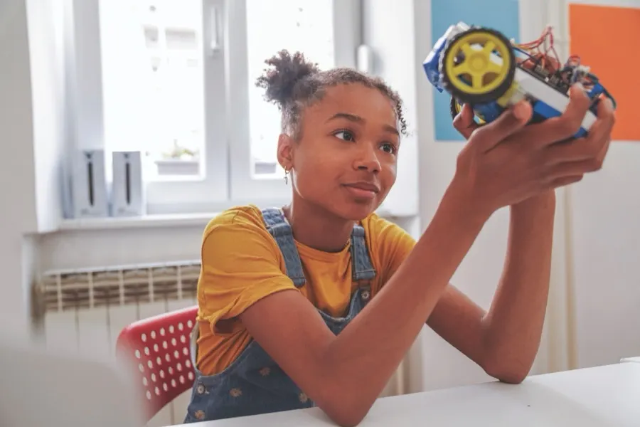 A student examining a hands-on classroom project